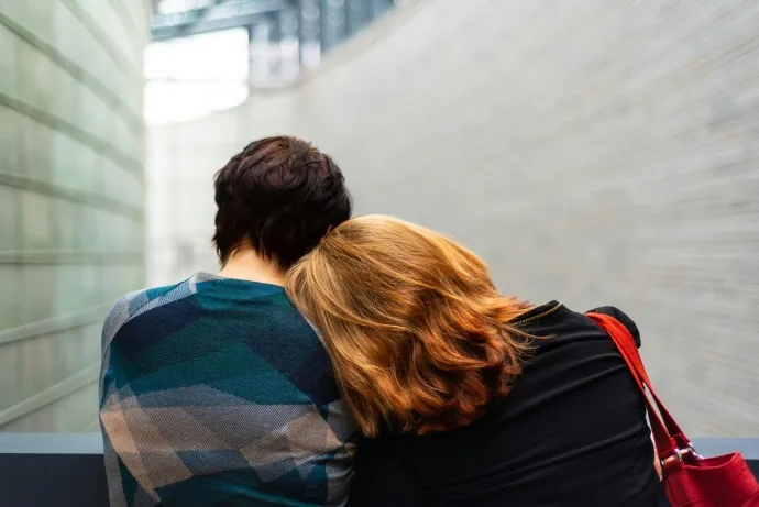 Two people offer one another a supportive embrace.