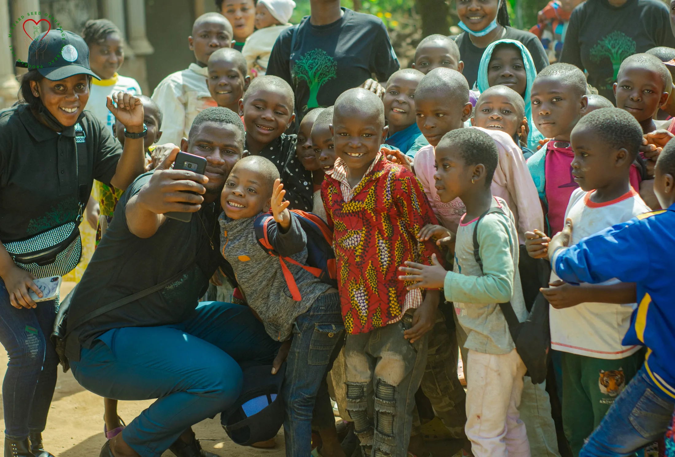 Young people and adults share a moment at an outdoor community gathering.